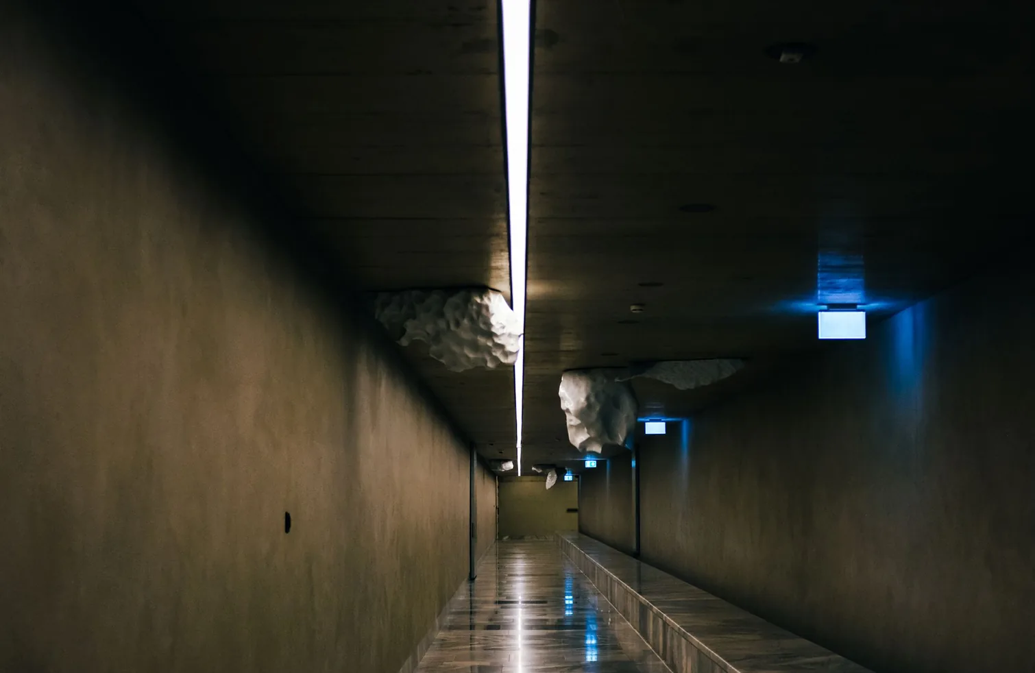 Continuous LED ceiling lighting in a modern hallway