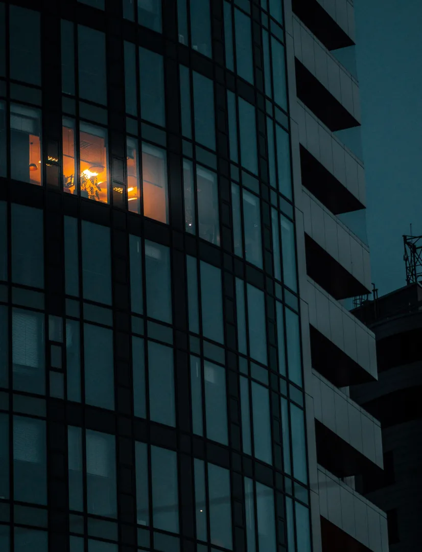Illuminated glass office building at night