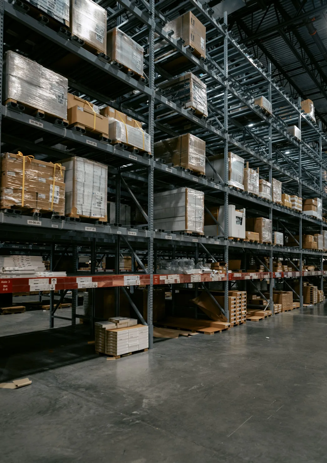 Shelving and overhead lighting inside an industrial warehouse